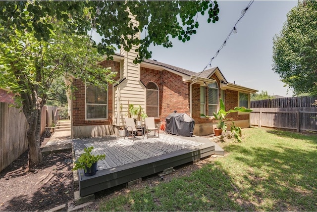 back of house featuring a yard and a deck