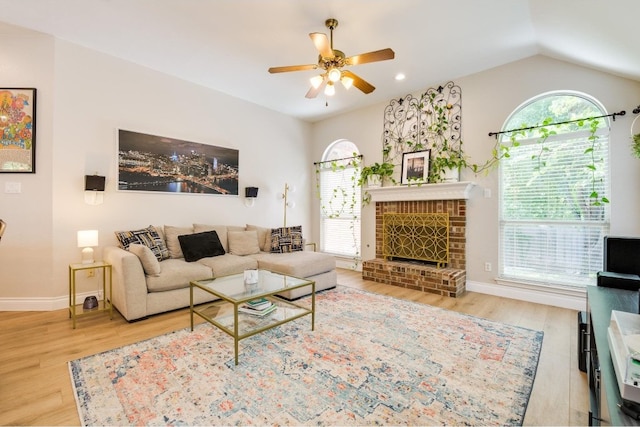 living room featuring ceiling fan, plenty of natural light, and wood-type flooring