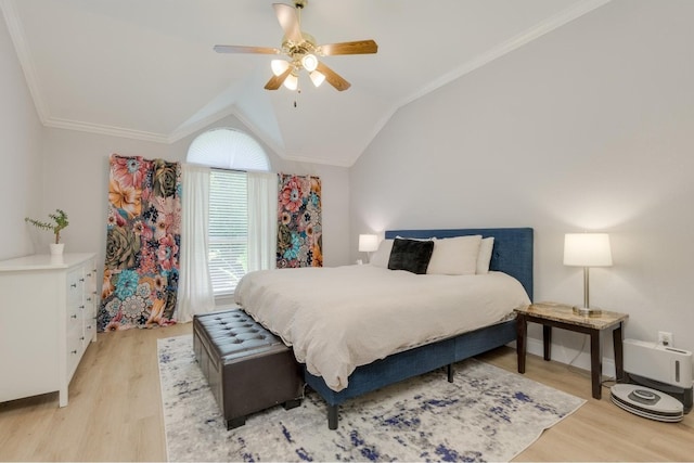 bedroom with light hardwood / wood-style flooring, ceiling fan, ornamental molding, and vaulted ceiling