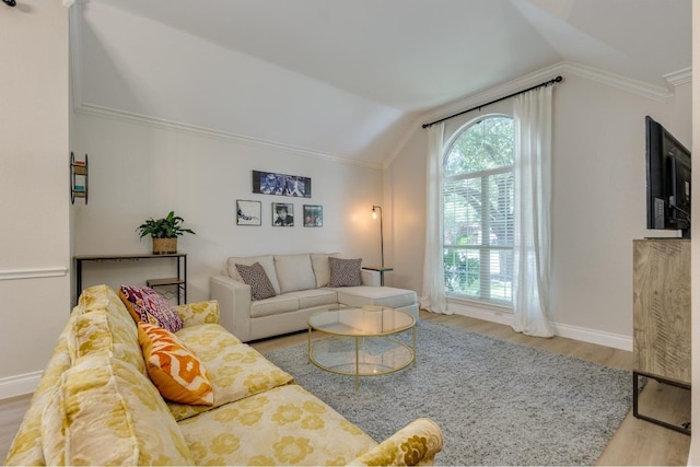 living room featuring crown molding, vaulted ceiling, and hardwood / wood-style flooring