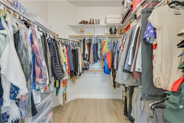 walk in closet featuring light hardwood / wood-style flooring