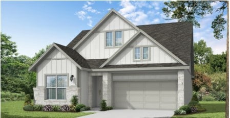 view of front of home featuring a garage and a front lawn