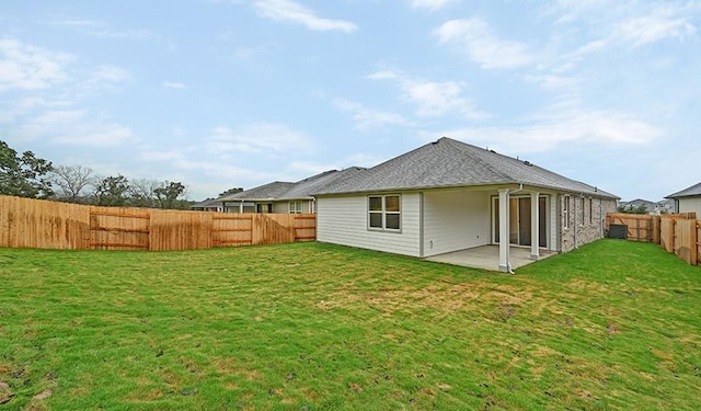 back of house with a yard and a patio area