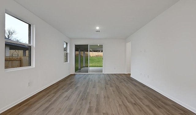 unfurnished room with hardwood / wood-style flooring