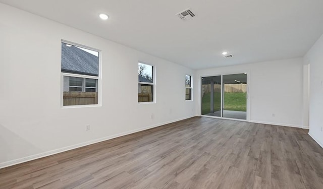 unfurnished room with light wood-type flooring