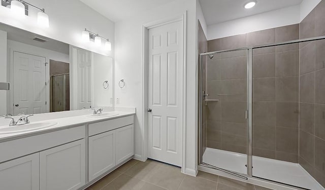 bathroom featuring vanity, tile patterned floors, and walk in shower