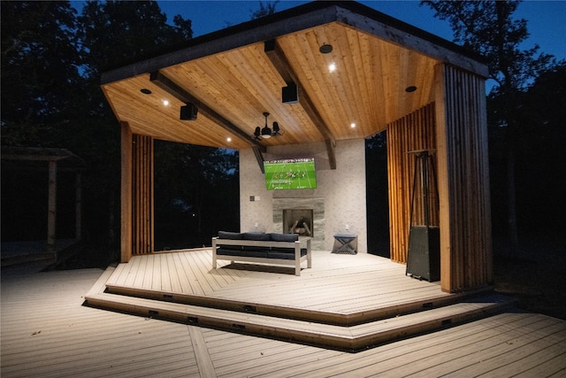 deck at night with exterior fireplace