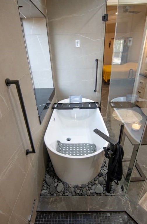 bathroom with tile patterned flooring and a bathtub