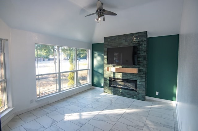 unfurnished living room featuring lofted ceiling, a healthy amount of sunlight, and ceiling fan