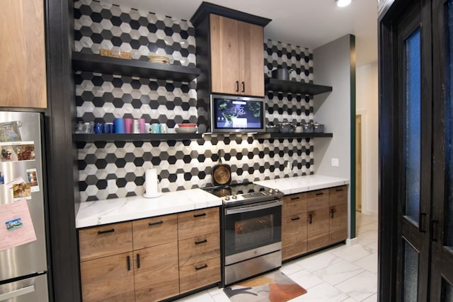 kitchen with appliances with stainless steel finishes and tasteful backsplash