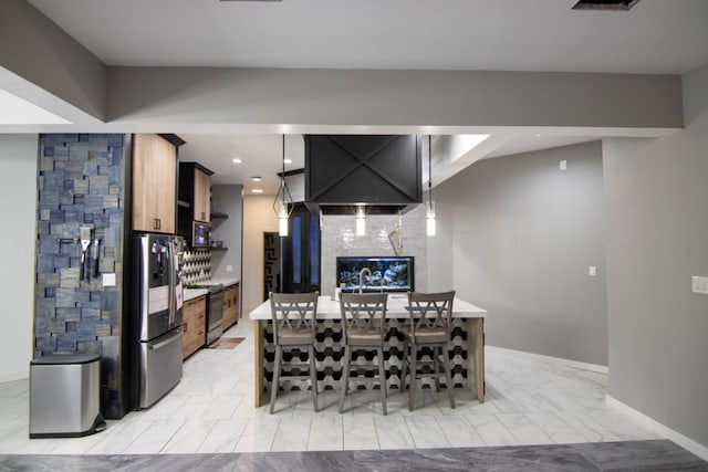 kitchen with a kitchen breakfast bar, stainless steel appliances, and kitchen peninsula