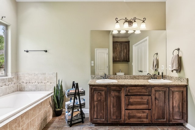 bathroom featuring tiled bath and vanity