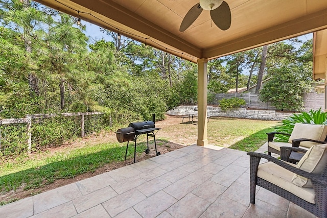 view of patio with area for grilling and ceiling fan