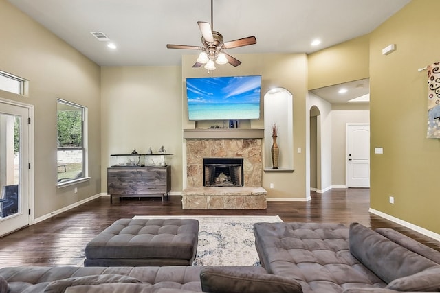 living room with ceiling fan, a fireplace, and dark hardwood / wood-style floors