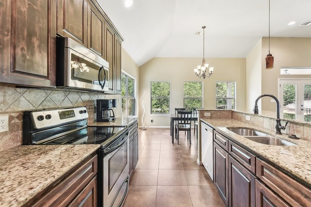 kitchen featuring pendant lighting, vaulted ceiling, an inviting chandelier, sink, and appliances with stainless steel finishes