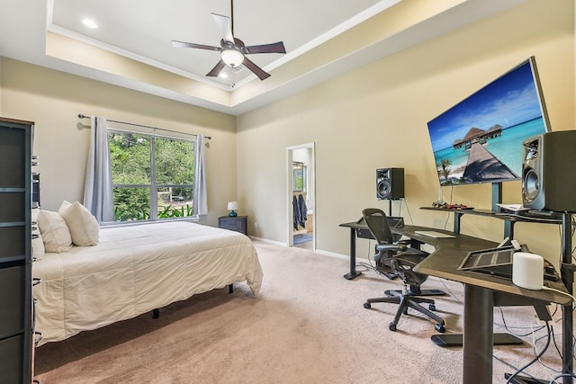 bedroom with crown molding, a raised ceiling, ceiling fan, and carpet floors