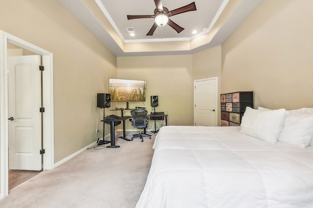 bedroom featuring a raised ceiling, ceiling fan, and carpet