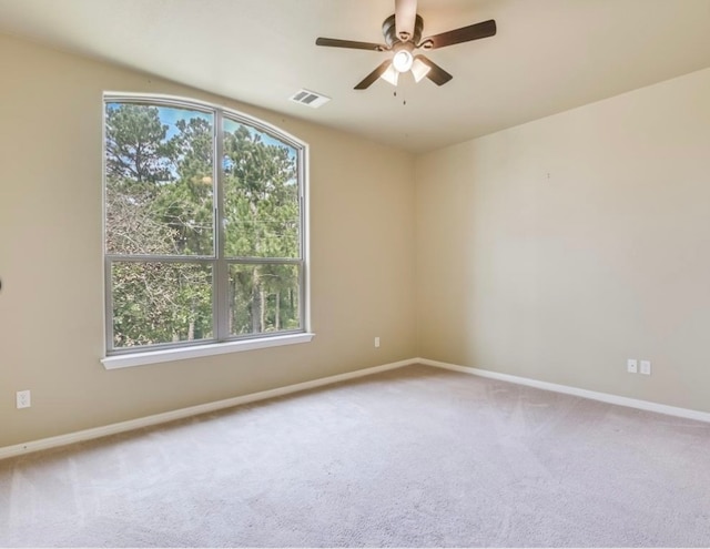 carpeted spare room with ceiling fan