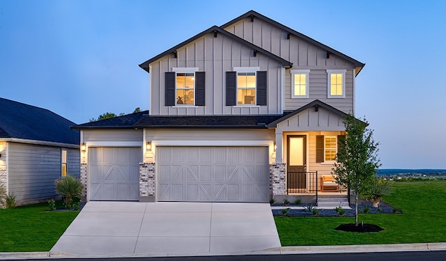 view of front of property with a front yard and a garage