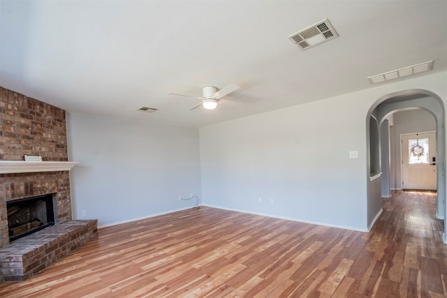 unfurnished living room with light hardwood / wood-style floors, ceiling fan, and a fireplace