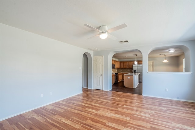 interior space with light hardwood / wood-style flooring and ceiling fan