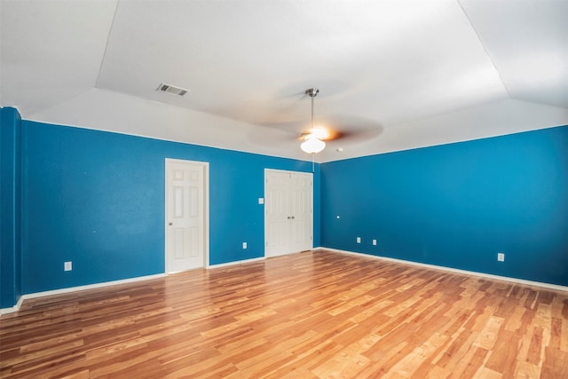 unfurnished room featuring lofted ceiling, hardwood / wood-style flooring, and ceiling fan