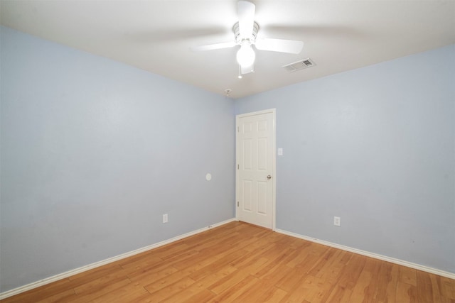 spare room with light wood-type flooring and ceiling fan