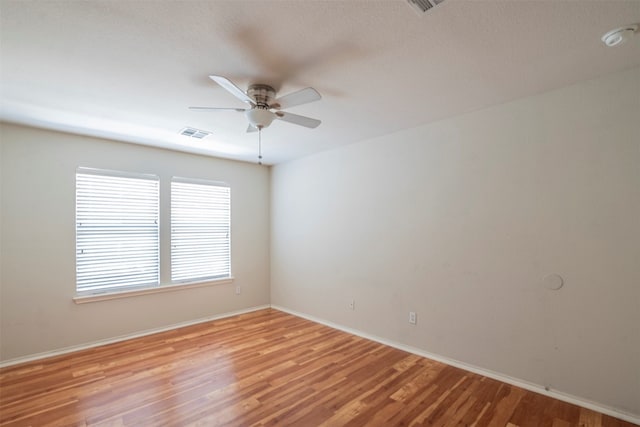 spare room with ceiling fan and light hardwood / wood-style flooring