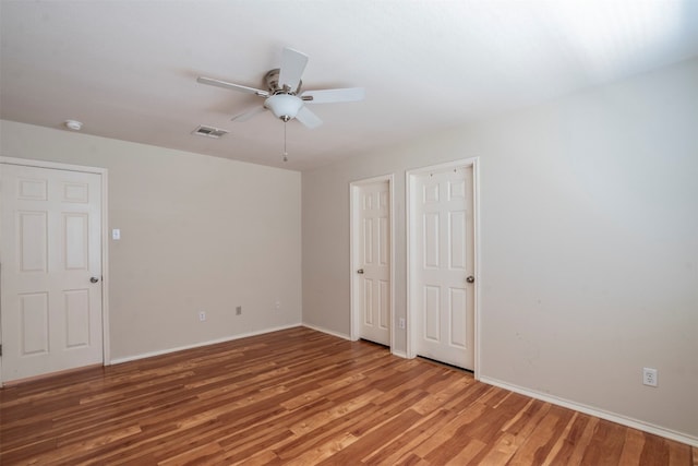 spare room with ceiling fan and hardwood / wood-style floors