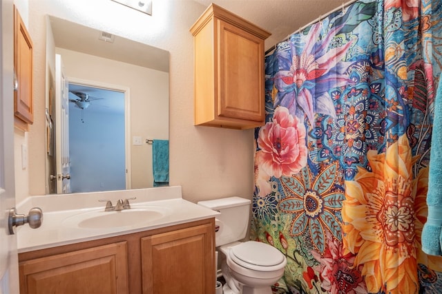 bathroom with a textured ceiling, vanity, toilet, and a shower with curtain