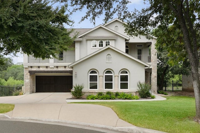 view of front of home with a balcony, a garage, and a front yard