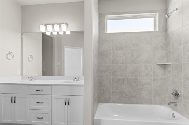 bathroom with vanity and tiled shower / bath combo