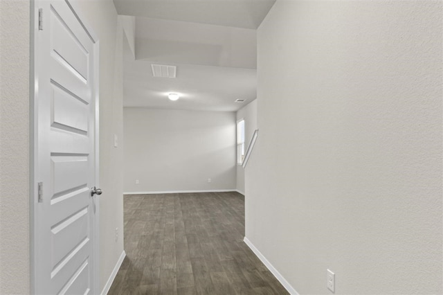 hallway with dark wood-type flooring