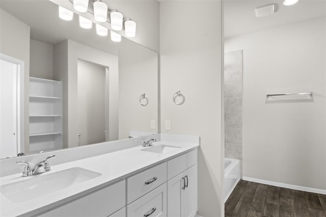 bathroom featuring shower / bath combination, wood-type flooring, and vanity