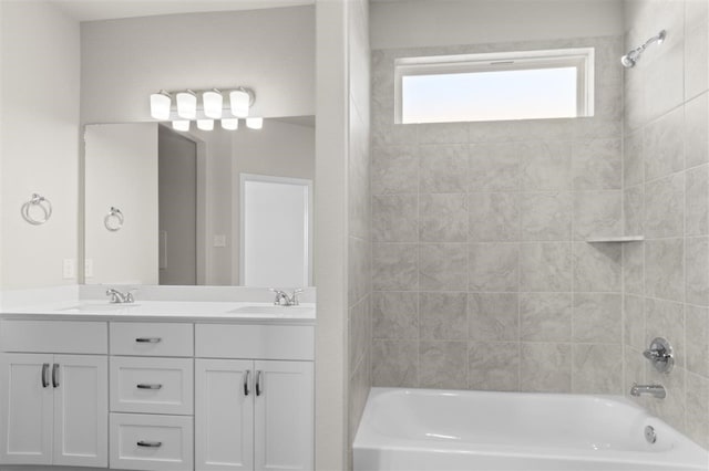 bathroom featuring vanity and tiled shower / bath combo