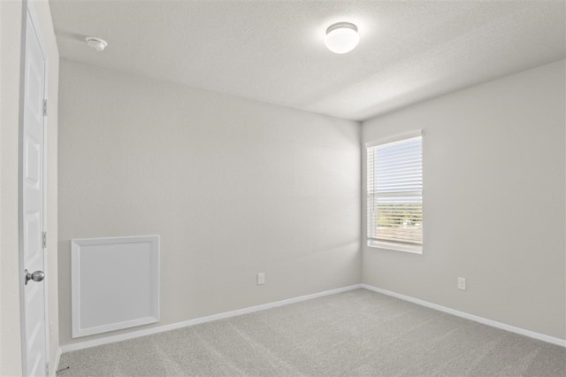 unfurnished room with light colored carpet