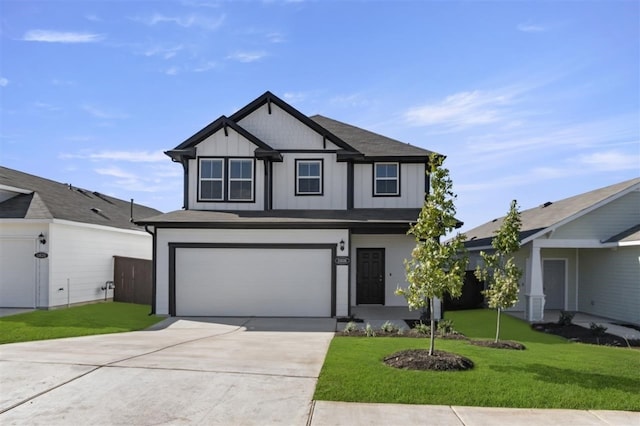 view of front of property with a front yard and a garage