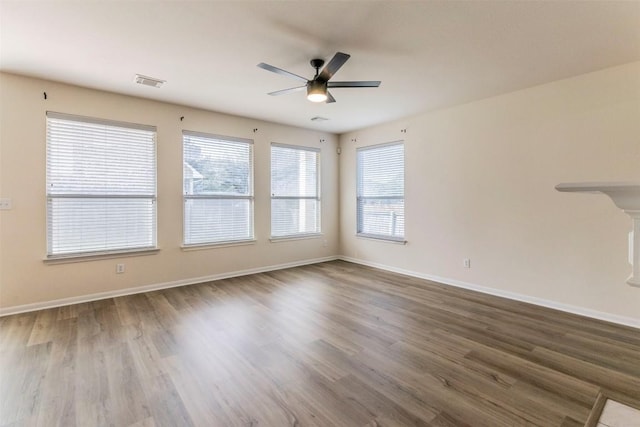 1001 Winding Creek Pl, Round Rock, TX 78665 - empty room with a ceiling fan, dark wood finished floors, and baseboards