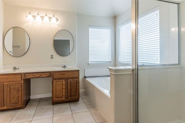 full bathroom featuring a sink, tile patterned flooring, double vanity, and a bath
