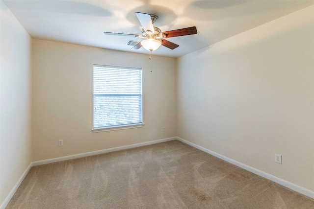 spare room featuring ceiling fan and light colored carpet