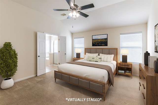 carpeted bedroom with ceiling fan, vaulted ceiling, and connected bathroom