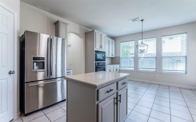 1001 Winding Creek Pl, Round Rock, TX 78665 - kitchen featuring black appliances, light tile patterned flooring, light countertops, arched walkways, and a center island