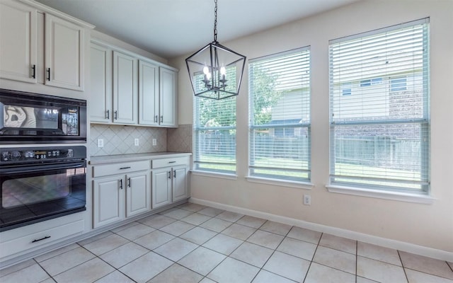 1001 Winding Creek Pl, Round Rock, TX 78665 - kitchen with black appliances, a chandelier, light countertops, baseboards, and decorative backsplash
