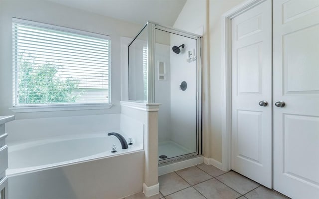 1001 Winding Creek Pl, Round Rock, TX 78665 - bathroom with a stall shower, a garden tub, tile patterned flooring, and baseboards