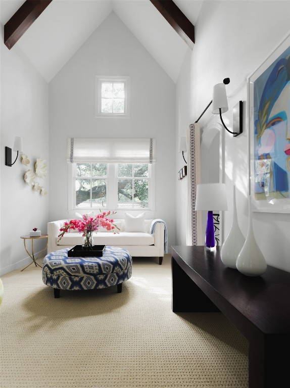 interior space with high vaulted ceiling, a healthy amount of sunlight, and beam ceiling