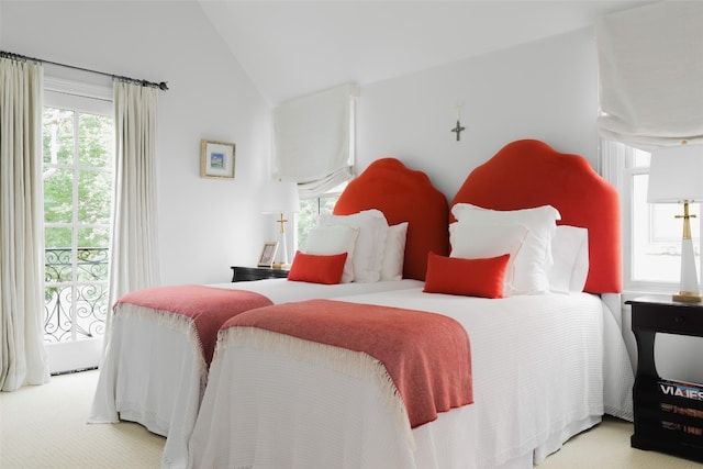 carpeted bedroom featuring lofted ceiling