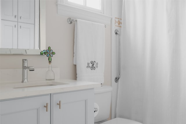 bathroom featuring toilet and vanity