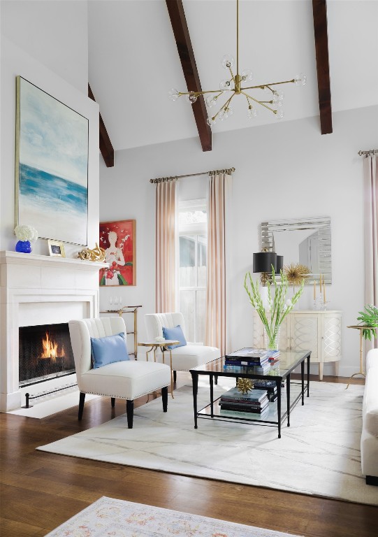 sitting room with high vaulted ceiling, wood-type flooring, a chandelier, and beam ceiling