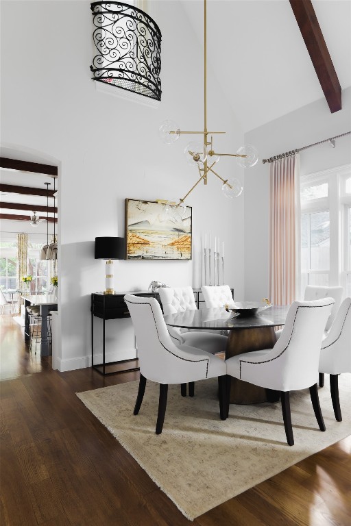 dining room with high vaulted ceiling, a notable chandelier, wood-type flooring, and beam ceiling