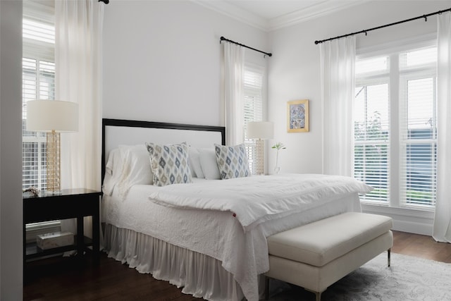 bedroom featuring ornamental molding and hardwood / wood-style flooring